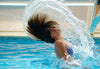 woman swimming and whipping hair back