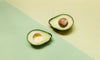Sliced Avocado Halves On Two Color Background