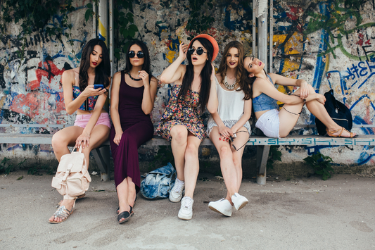 five women sitting on a bench