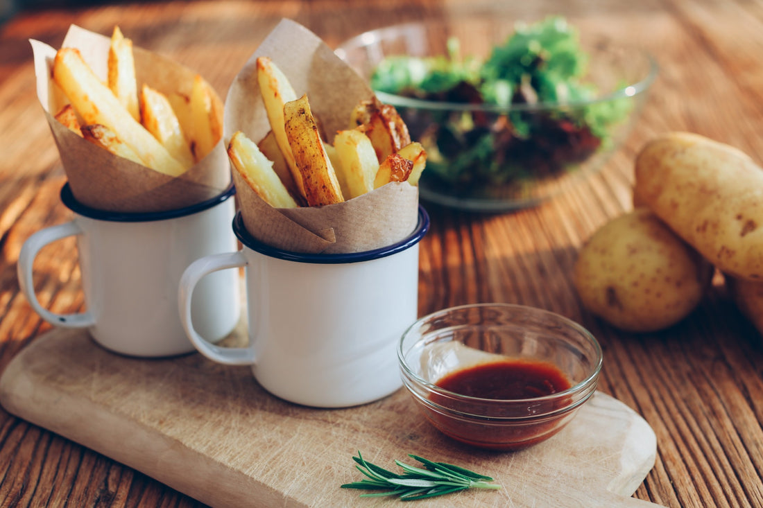 Fresh Air Fried French Fries In Metal Mugs With Barbecue Sauce Potatoes And Salad Greens