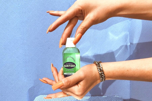 Hands Holding Bottle Of Hand Sanitizer