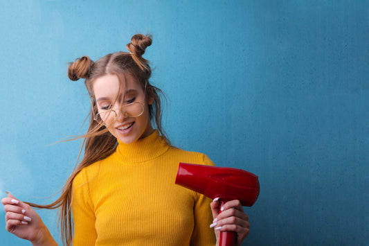 Woman In Yellow Sweater Using Red Hairdryer