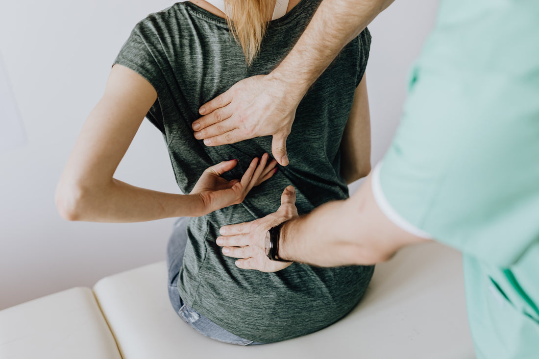 Woman Showing Chiropractor Her Back Pain