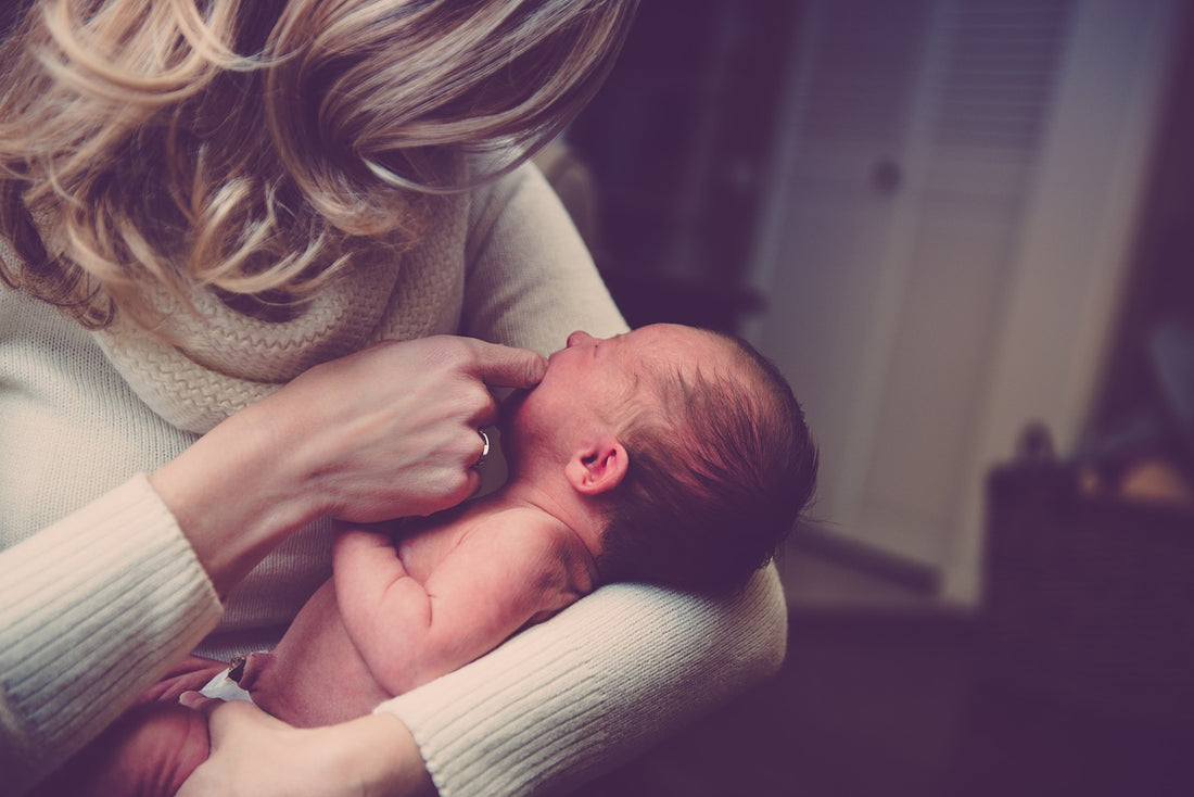 mother holding baby after birth