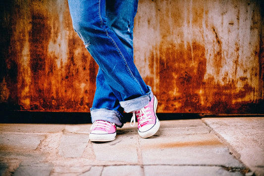 woman standing with pink shoes