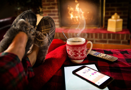 relaxing in front of fire place with coffee during holidays