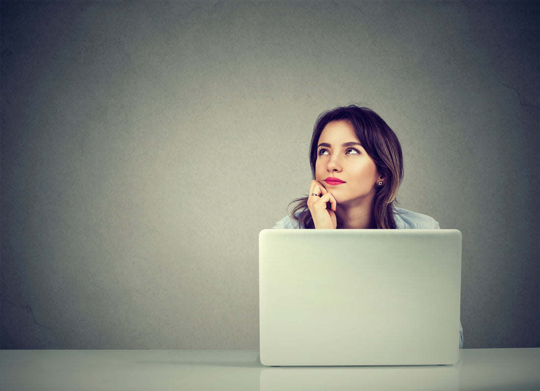 woman-sitting-at-laptop-while-thinking